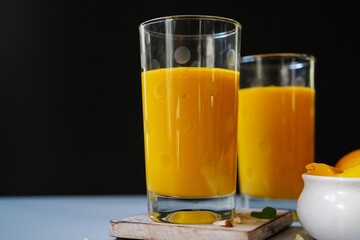 Homemade Mango Lassi | Traditional Indian smoothie with mangoes, selective focus
