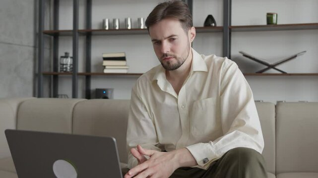 Pensive Businessman Recieving Bad News about Stock Market Crash on his Laptop