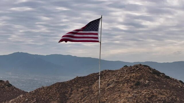 american flag on hill low angle drone