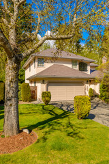 Obraz premium Two story luxury house with beautiful summer landscape in Vancouver, Canada, North America. Day time on June 2024.
