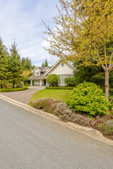 Two story luxury house with beautiful summer  landscape in Vancouver, Canada, North America. Day time on June 2024.