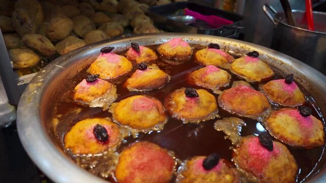 Traditional torrejas chapinas, fresh from the pot, golden and crispy, served at a fair stand. This delicious Guatemalan dish is prepared with bread soaked in honey and spices