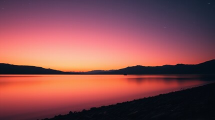 Fototapeta premium Vibrant sunset over calm lake with mountain silhouette and aurora lights