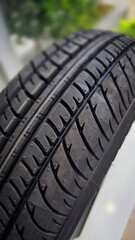 detailed image of a brand new car tire showcasing its intricate tread pattern for enhanced grip and performance