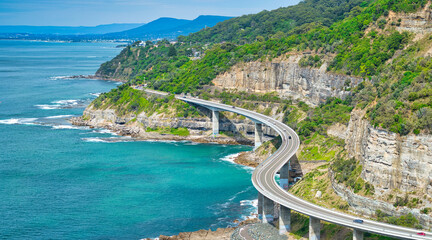 Elevated view of Sea Cliff Bridge hugging the cliffs above the sea