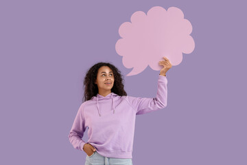 Portrait of beautiful African-American woman with blank speech cloud on purple background