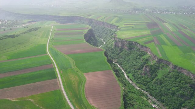 Forward reveal aerial shot of Dzoraget canyon on a spring day. Yaghdan village, Armenia.