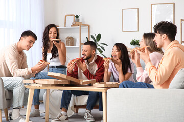 Happy friends eating pepperoni pizza at home