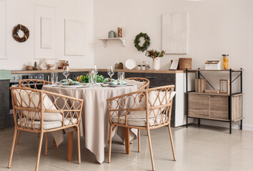 Beautiful Christmas table setting in interior of kitchen