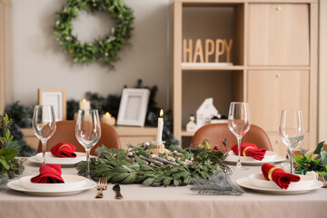 Dining table with beautiful setting for Christmas eve in room