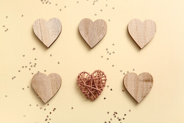 Composition with wooden hearts and sequins on color background. Valentine's Day celebration