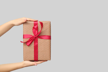 Female hands with gift box on white background. Valentine's Day celebration