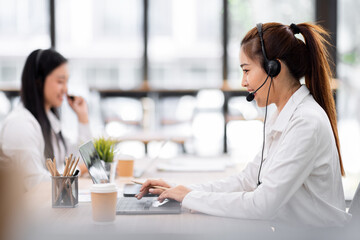 Asian call center team, customer service, telesales wearing headset or headphone talking with customer in the office. Customer Service Representative, Service, Call Center, 