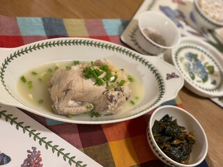 Samgyetang, a hearty Korean ginseng chicken soup, featuring a whole young chicken stuffed with rice, garlic, jujube, and herbs. A nourishing dish perfect for health and comfort.
