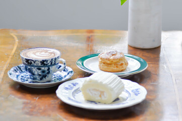choux cream or eclair , coconut roll and coffee