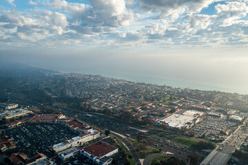 Naklejka premium Aerial view of San Clemente California coastline showcasing shopping center and I-5 freeway