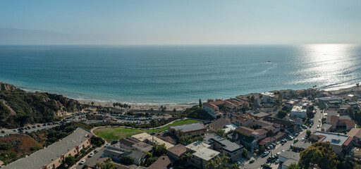 Fototapeta premium Panoramic aerial views of San Clemente coastline showcasing vibrant ocean, and sandy beach over The Loop