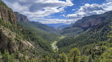 Towering rocky mountains framed by lush green forests and winding river