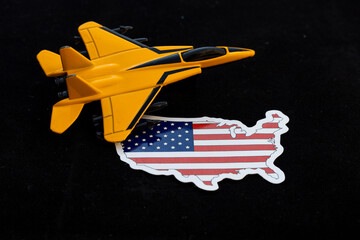 A toy fighter jet with a USA map on black background