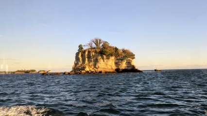 Naklejka premium sunset over the sea and an island