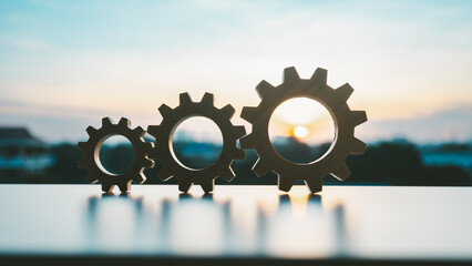 Gears from at blue urban and sunlight background. concept of a teamwork cooperation idea.