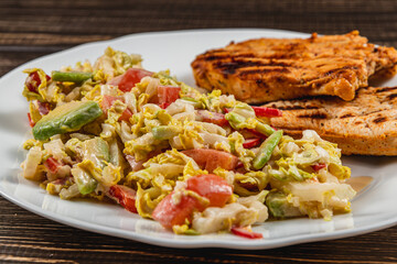 Delicious Grilled turkey Served with a salad on a Rustic Wooden Dining Table