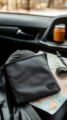 Black pouch bag on a map in a car.