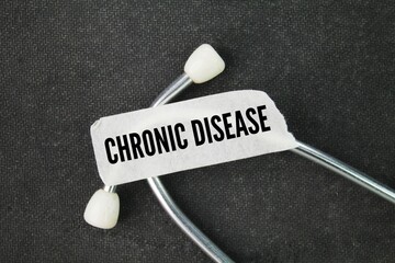 stethoscope and sticker with the word chronic disease. disease or condition that usually lasts for...