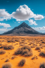 Obraz premium Majestic mountain rises above vibrant orange landscape under a bright blue sky
