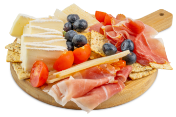 Charcuterie board. Wooden cutting board. Fruit and cheese platter. Cherry tomatoes and blueberries. Brie and parmesan cheese. Crackers and prosciutto. Sliced cheese and deli meat gourmet party snack. 