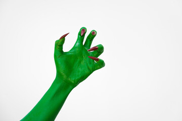 Green  female monster hand with sharp nails, isolated on a white background, exudes horror and...