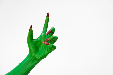 Green  female monster hand with sharp nails, isolated on a white background, exudes horror and...