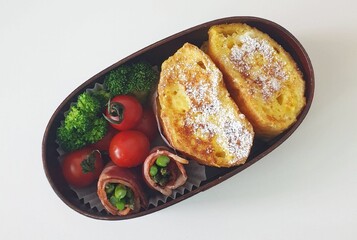 A traditional Korean dosirak, beautifully arranged with rice, assorted banchan, and savory proteins. Balanced and visually inviting, it’s a portable meal packed with vibrant flavors.

