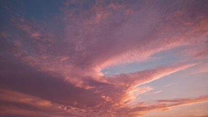 Beautiful pastel sky scene at dusk with pink and purple clouds. Dreamy nature background for girly wallpaper, header and banner.