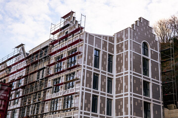 Fototapeta premium Construction of Modern Residential Buildings Under Clear Blue Sky Showcasing Architectural Design and Progress