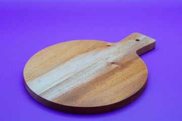 wooden cutting board on purple background