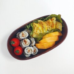 A traditional Korean dosirak, beautifully arranged with rice, assorted banchan, and savory proteins. Balanced and visually inviting, it’s a portable meal packed with vibrant flavors.
