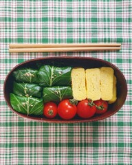 A traditional Korean dosirak, beautifully arranged with rice, assorted banchan, and savory proteins. Balanced and visually inviting, it’s a portable meal packed with vibrant flavors.
