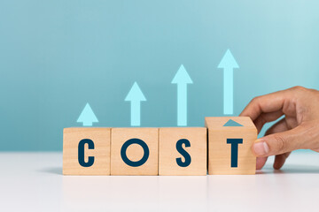 Cost, lean or cost reduction, expense, interest rates and dividends. Hand hold wooden block with the word cost and arrow up for increase of business profits