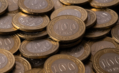 Pile of coins in denominations of 100 Kazakhstani tenge