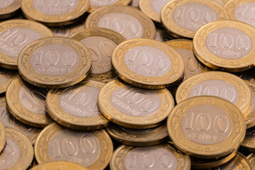 Pile of coins in denominations of 100 Kazakhstani tenge