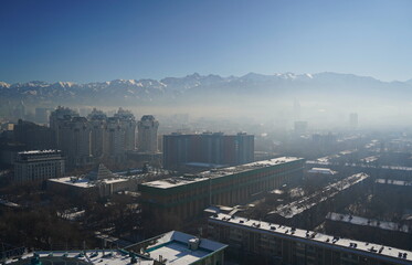 Almaty, Kazakhstan - 12.13.2024 : Heavy smog over the city. Residential buildings, commercial buildings and various architectures.