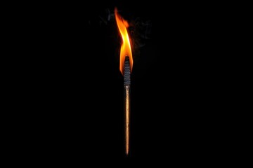new year gathering concept. A single lit matchstick with a bright flame against a dark background, symbolizing light, fire, and ignition.