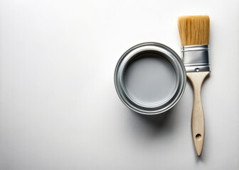 Can of Grey Paint and Brush on White Background with Copy Space for Creative Projects, Home Renovation, and Artistic Inspiration Needs
