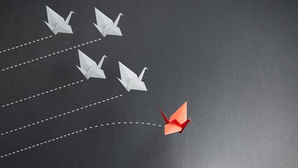 Red paper origami swan have individual direction from unique white swans in different way. Business strategy and opportunity concept.3D rendering on black background. © feng