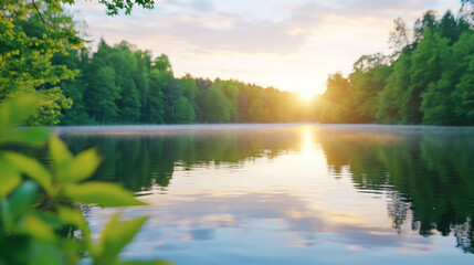 Fototapeta premium Serene sunrise over a tranquil lake surrounded by lush greenery.