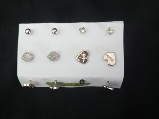 A closeup shot of a white jewelery case with rhinestones brooch in black background. photo taken in...