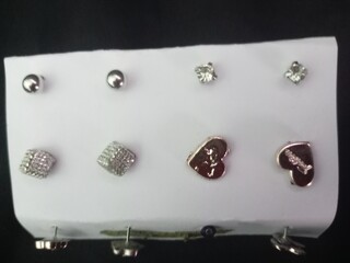 A closeup shot of a white jewelery case with rhinestones brooch in black background. photo taken in...