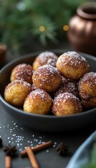 A bowl of golden, sugar-dusted pastries, perfect for festive gatherings and celebrations.