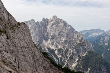 Panoramic view of rugged mountain ridge Prisank in majestic Julian Alps seen from top of summit...